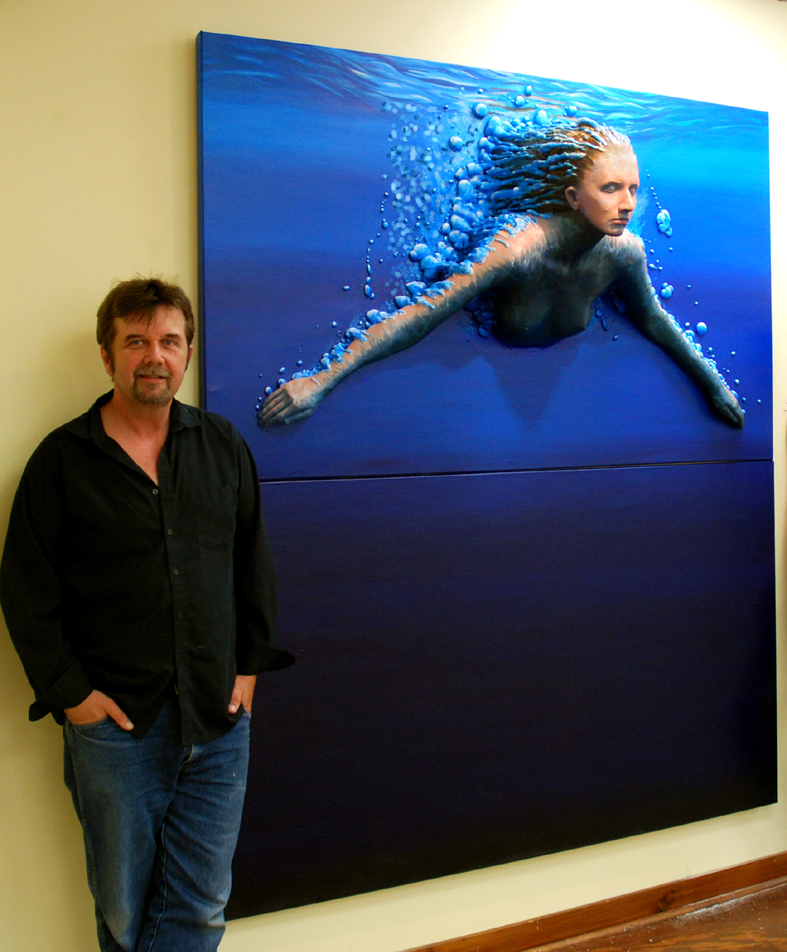 Steve Wilson standing beside one of his artworks.